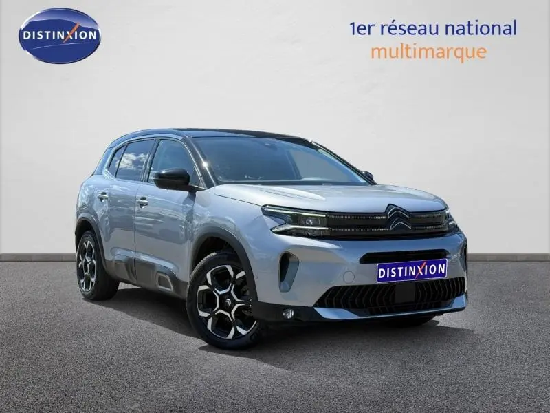 Vue 3/4 avant droite du Citroën C5 Aircross gris acier avec jantes alu noires et toit noir contrasté.