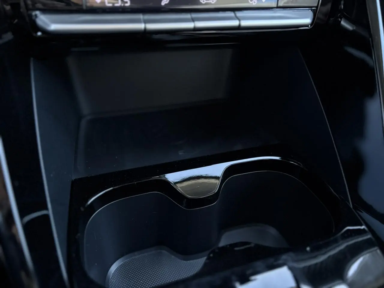 Gros plan sur la console centrale noire brillante avec porte-gobelets du Citroën C3 Aircross 2025 gris Mercury.