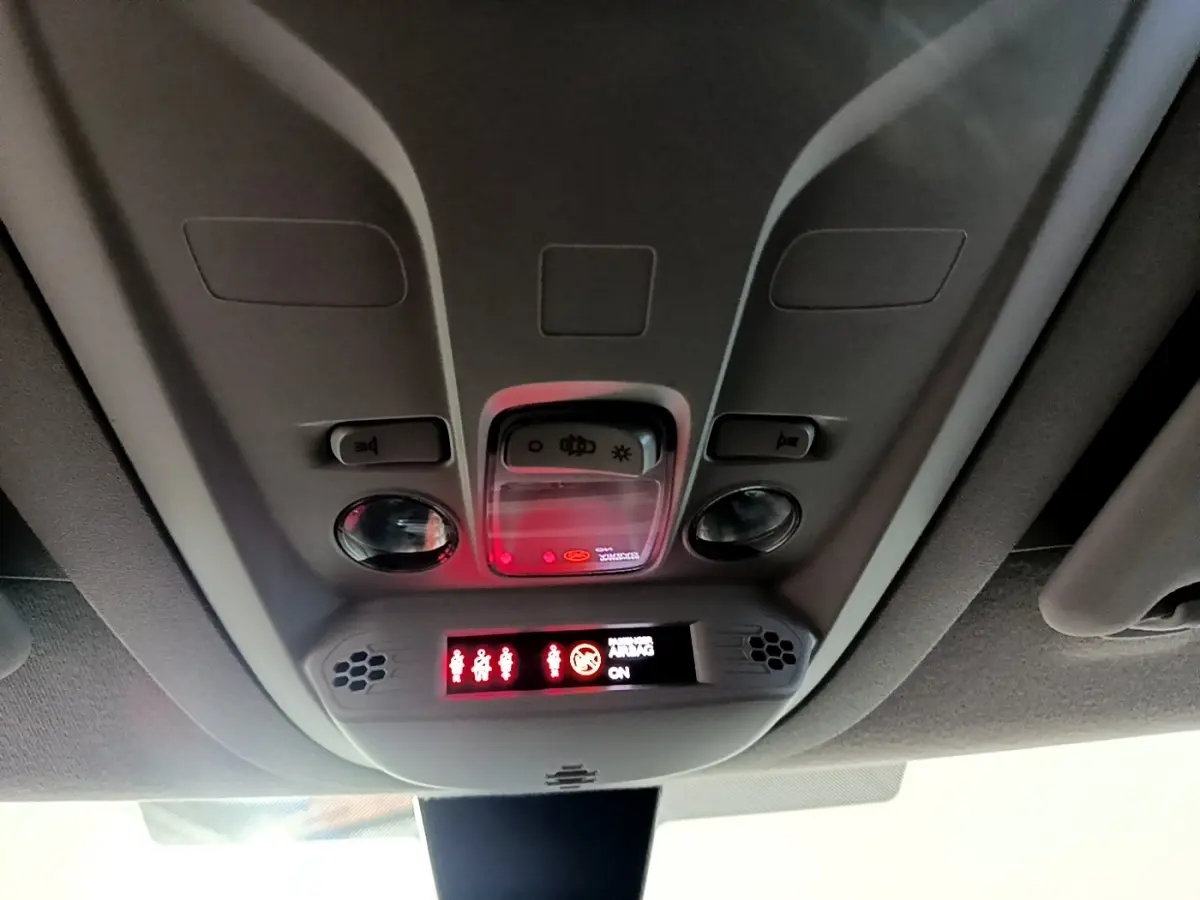 Vue intérieure du plafonnier du Citroën Berlingo blanc 2019 avec éclairage et indicateurs rouges allumés.