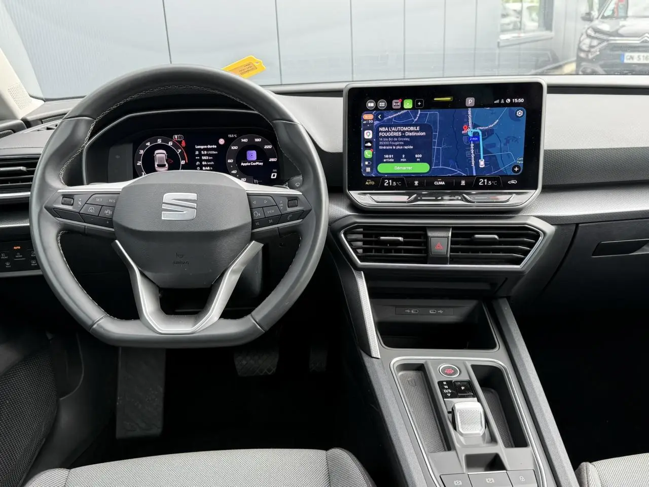 Vue intérieure frontale du tableau de bord et volant cuir noir de la SEAT LEON 1.5 TSI 2025 avec écran tactile et affichage numérique.