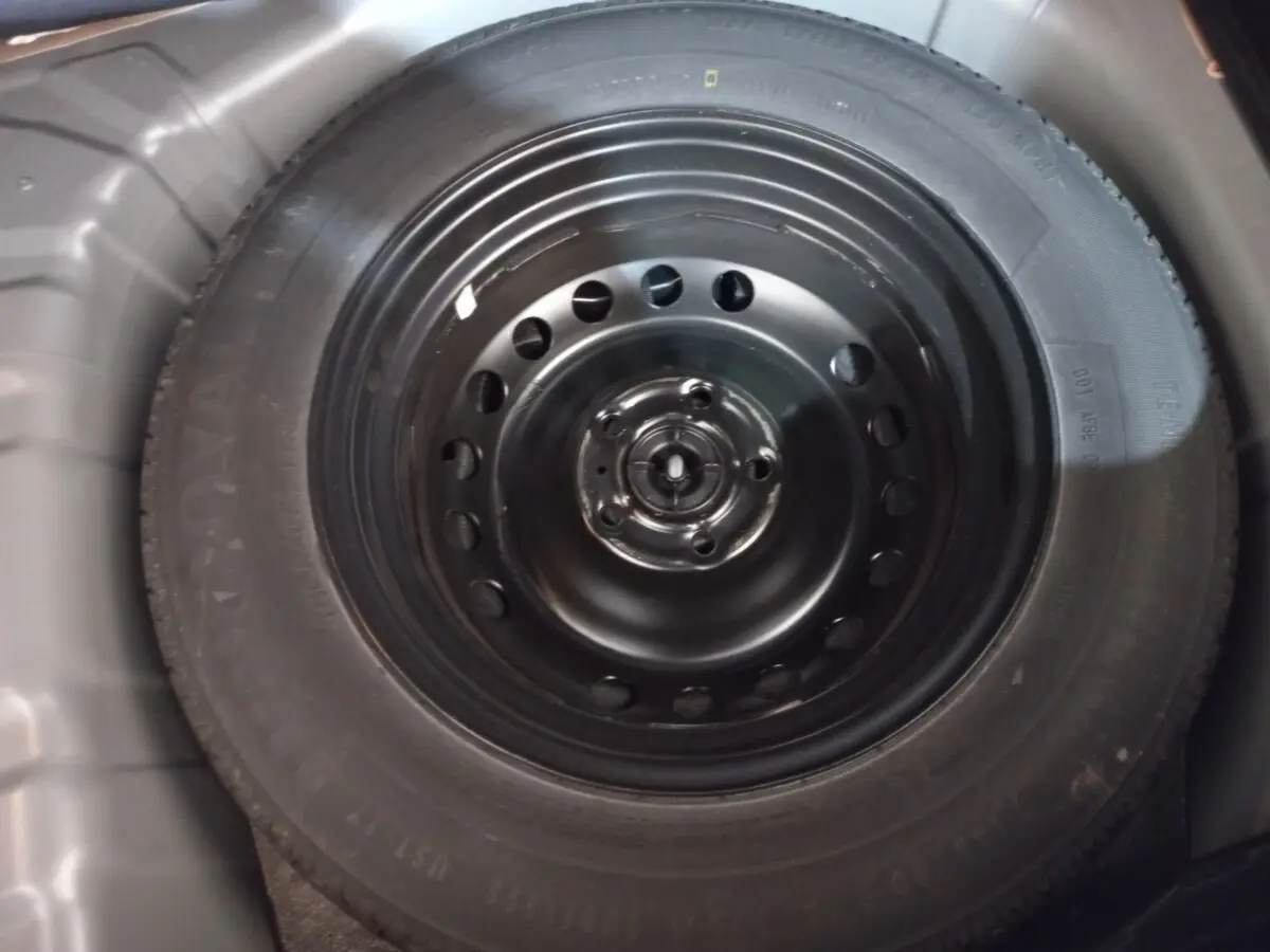 Gros plan sur la roue de secours noire dans le coffre du Renault Captur Business TCe 100 gris clair 2020.