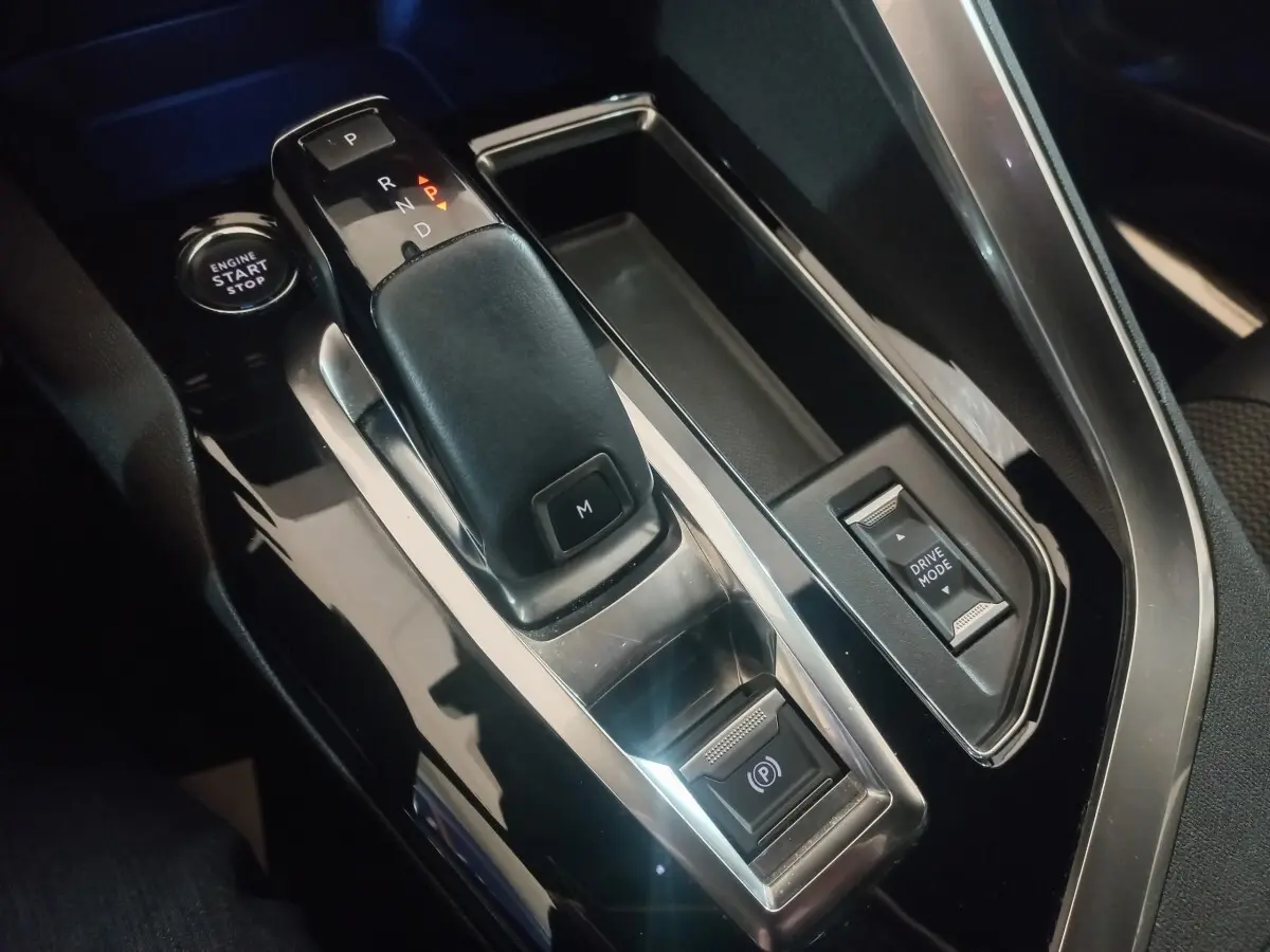 Gros plan sur la console centrale noire du Peugeot 3008 GT 2022 avec levier de boîte auto et bouton start/stop.