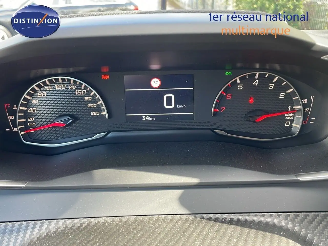 Tableau de bord numérique du Peugeot 2008 2024, affichage vitesse à 0 km/h et compte-tours avec fond noir texturé.
