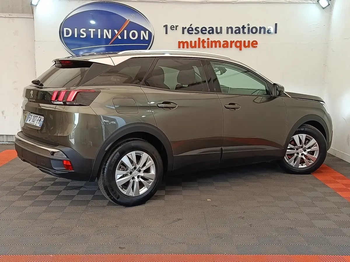 Peugeot 3008 gris foncé vue de profil côté gauche, avec feux arrière LED et jantes alliage visibles.