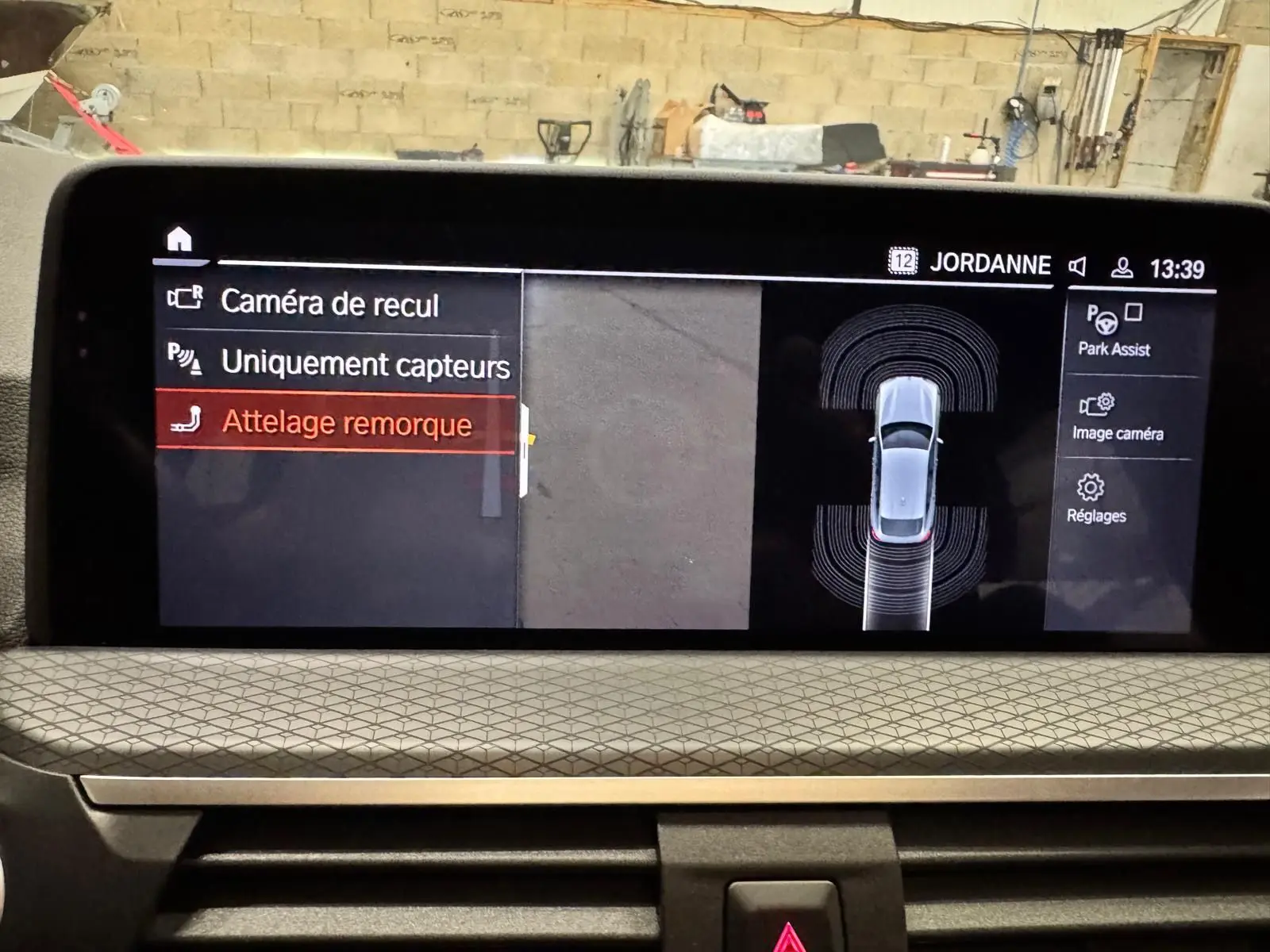 Écran multimédia du BMW X4 XDrive 20d 2020 affichant l'option attelage remorque en vue intérieure tableau de bord.