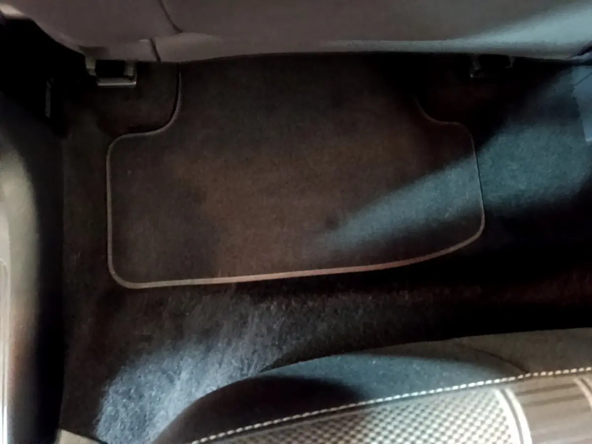 Tapis de sol noir côté passager avant du Volkswagen T-Roc gris foncé 2021, vue rapprochée intérieure.