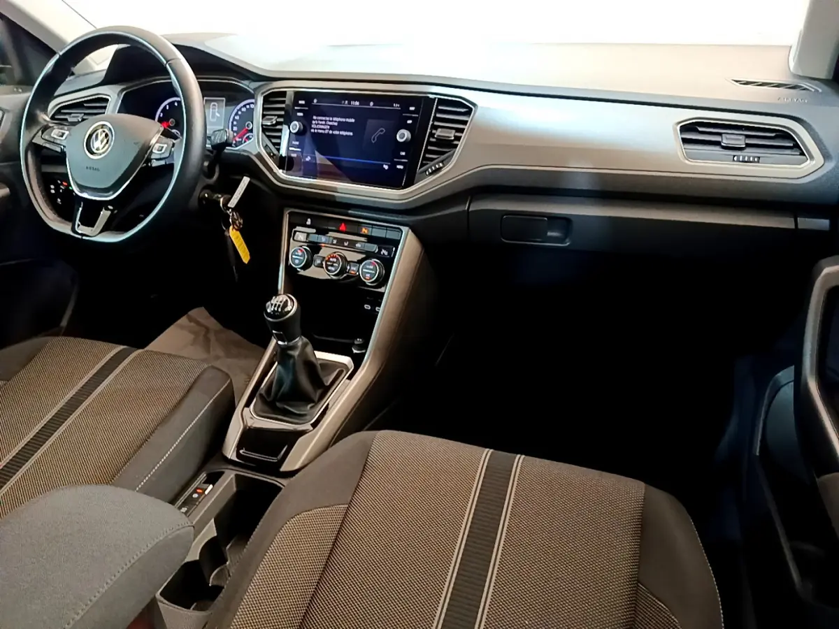 Intérieur du Volkswagen T-Roc 1.0 TSI 110 Lounge Business 2021, vue du poste de conduite avec volant cuir et boîte manuelle.