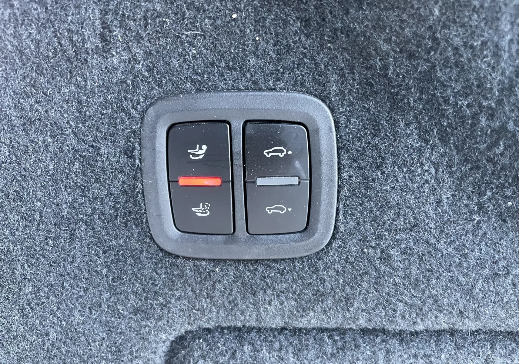 Gros plan sur les boutons de réglage des sièges et hayon dans l'habitacle du Porsche Cayenne Coupé E-Hybrid noir.