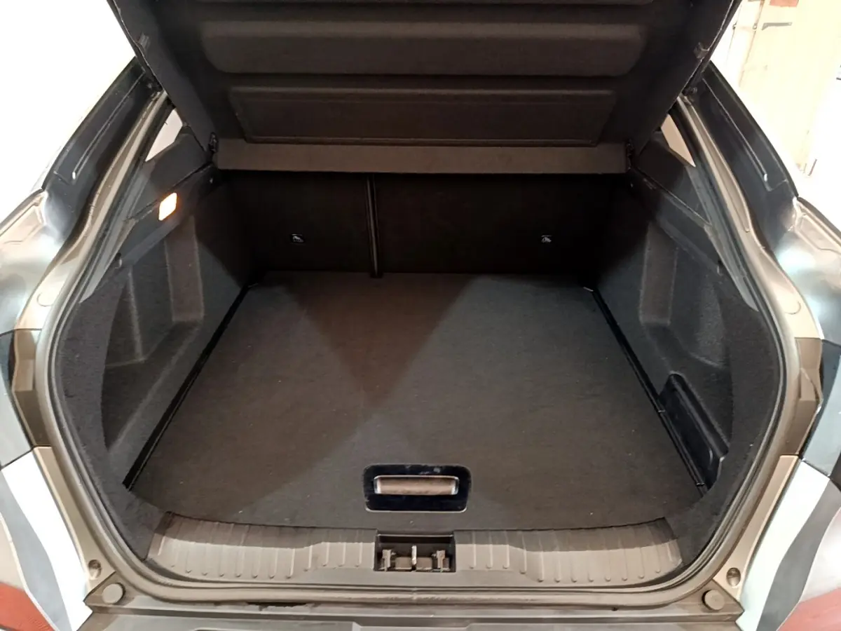 Coffre ouvert gris foncé du Renault Arkana Business E-TECH 145, vue arrière montrant l'espace de chargement vide.
