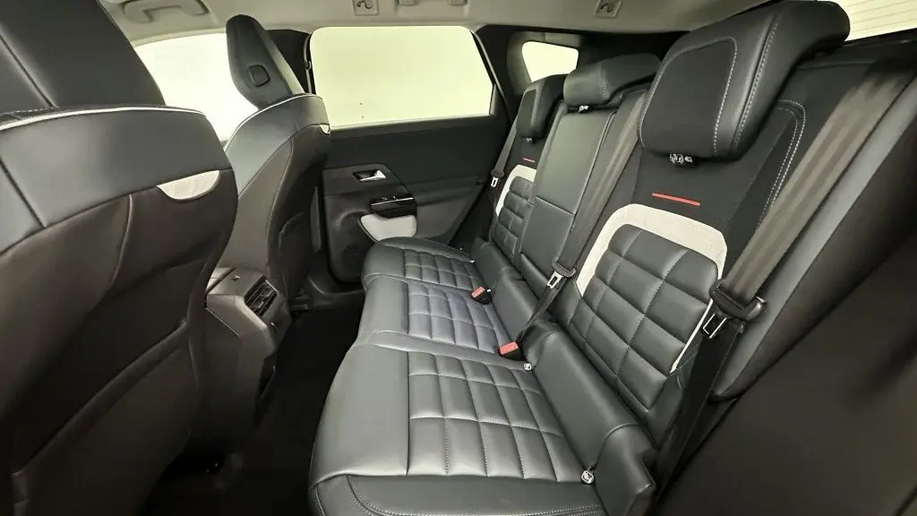 Vue intérieure arrière côté droit des sièges en tissu brun et toile noire du Citroën C5 Aircross hybride 2026.