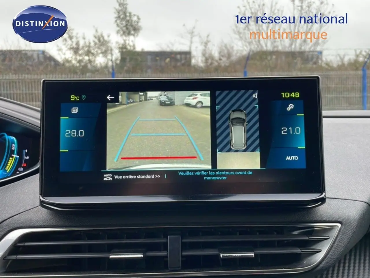 Vue intérieure du tableau de bord du Peugeot 3008 gris Artense, écran tactile affichant la caméra de recul et la température.