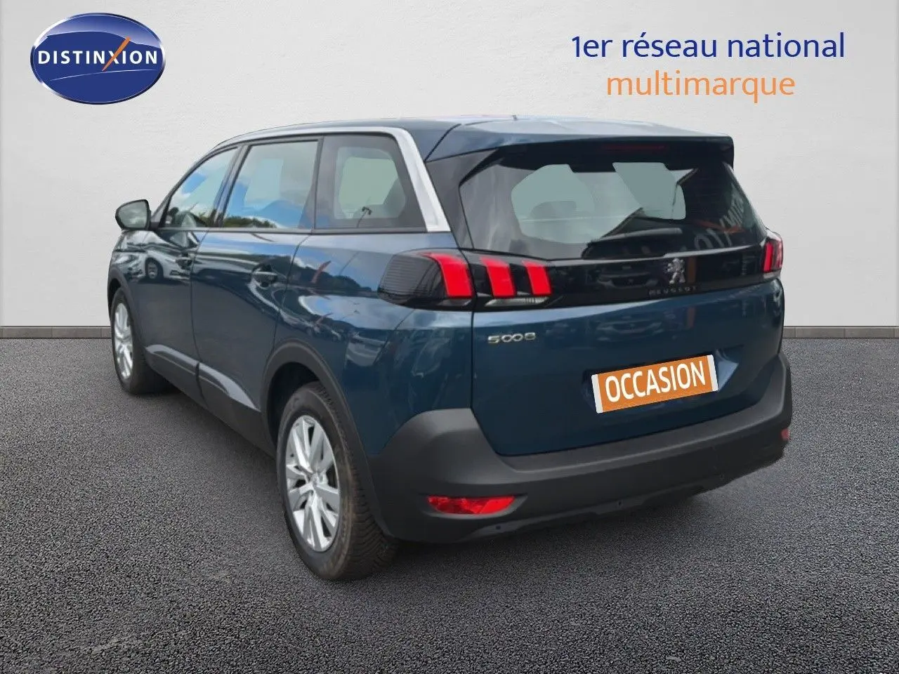 Vue 3/4 arrière droite d'un Peugeot 5008 bleu Célèbes métal avec feux arrière à griffes et toit contrasté gris clair.