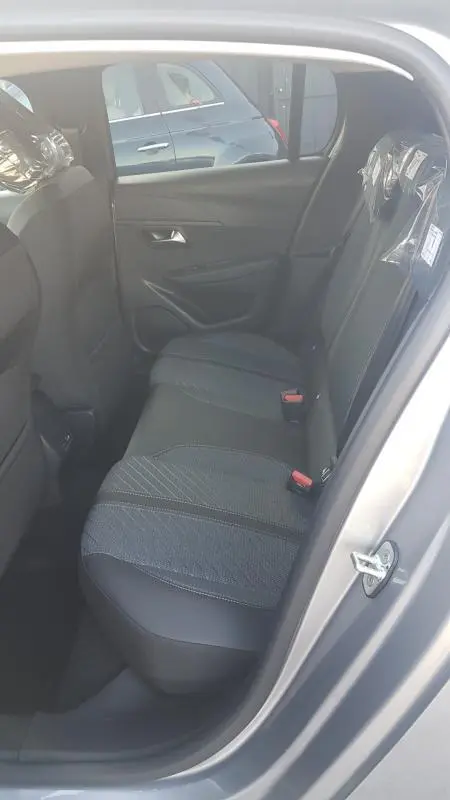 Vue intérieure côté droit des sièges arrière en tissu gris de la Peugeot 208 Hybrid 110 e-DCS6 Allure 2025.