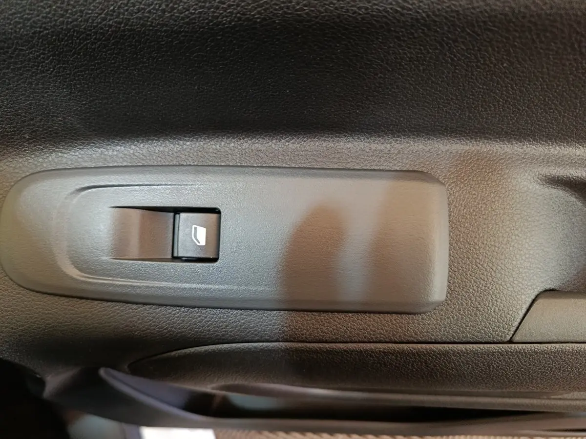 Gros plan sur l'interrupteur de lève-vitre électrique côté conducteur du Peugeot Partner blanc 2025.