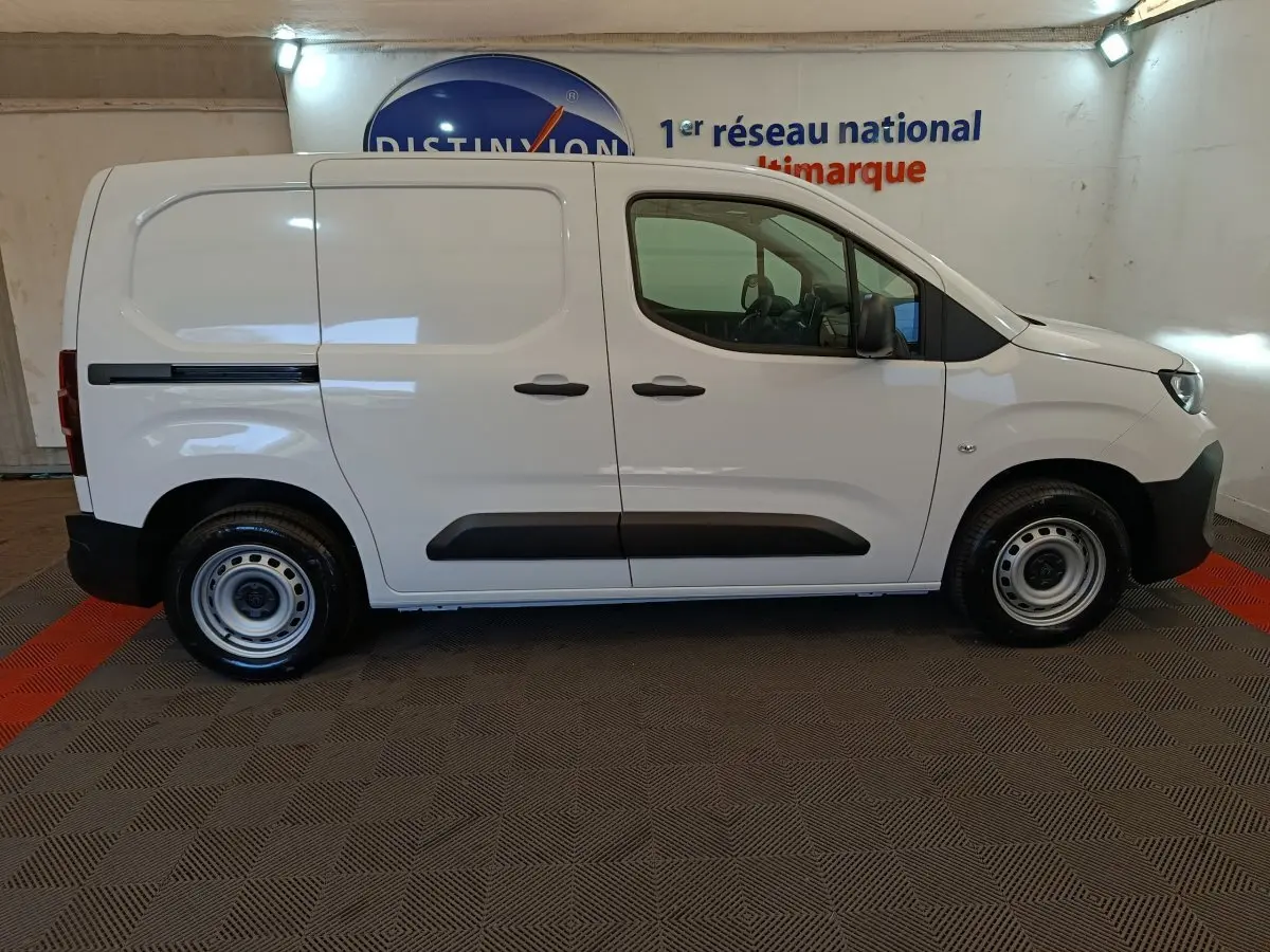 Peugeot Partner blanc vue de profil côté droit, fourgon utilitaire avec portes latérales pleines et jantes acier.