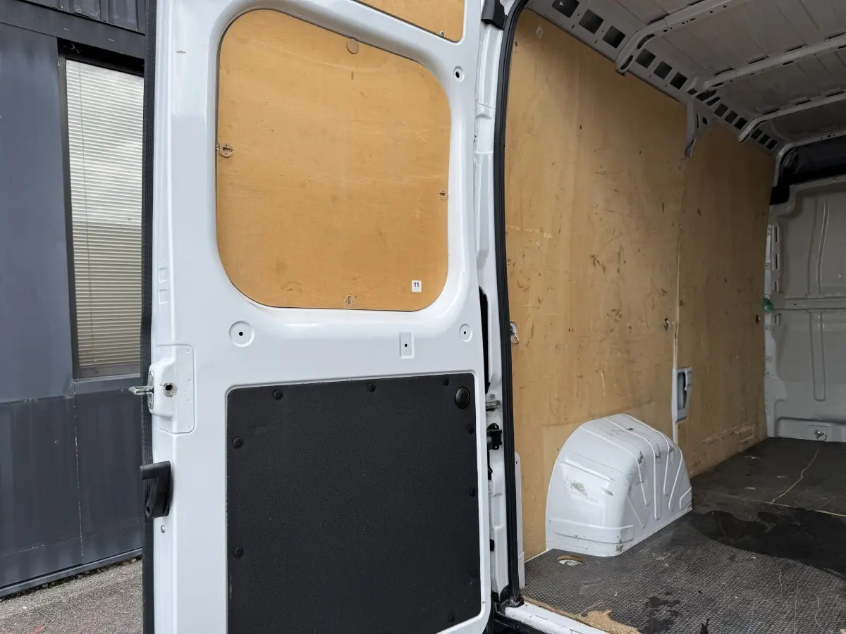 Vue intérieure arrière droite du Peugeot Boxer Fourgon blanc 2023, montrant l'espace de chargement avec parois en bois.