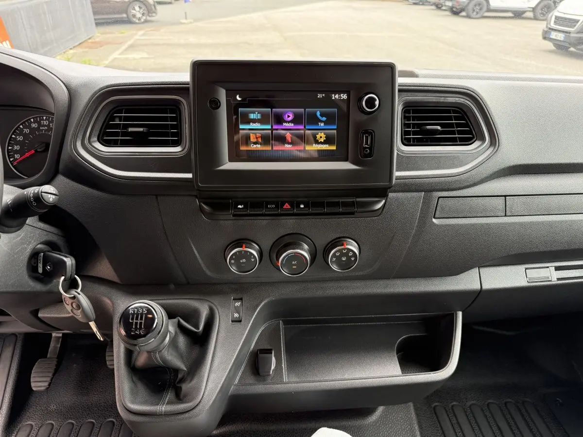 Vue intérieure du tableau de bord du Renault Master 2024 avec écran tactile central et levier de vitesses manuel.