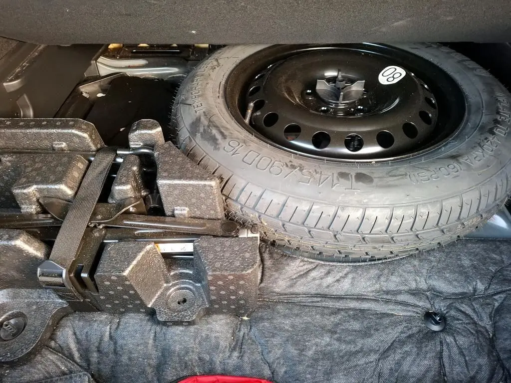 Gros plan sur les commandes d'assistance à la conduite sous le tableau de bord du Renault Arkana noir métal, finition Techno.