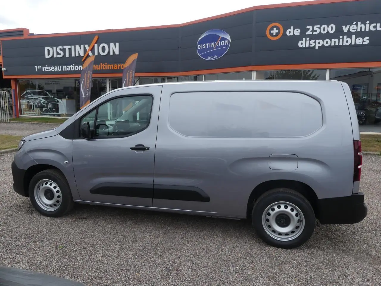 Vue latérale droite d'un Peugeot Partner gris métallisé 2025, utilitaire avec portes tôlées et jantes acier simples.