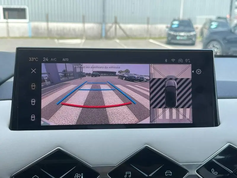 Écran intérieur du DS3 2024 montrant la caméra de recul avec vue arrière et vue 360° du véhicule en stationnement.