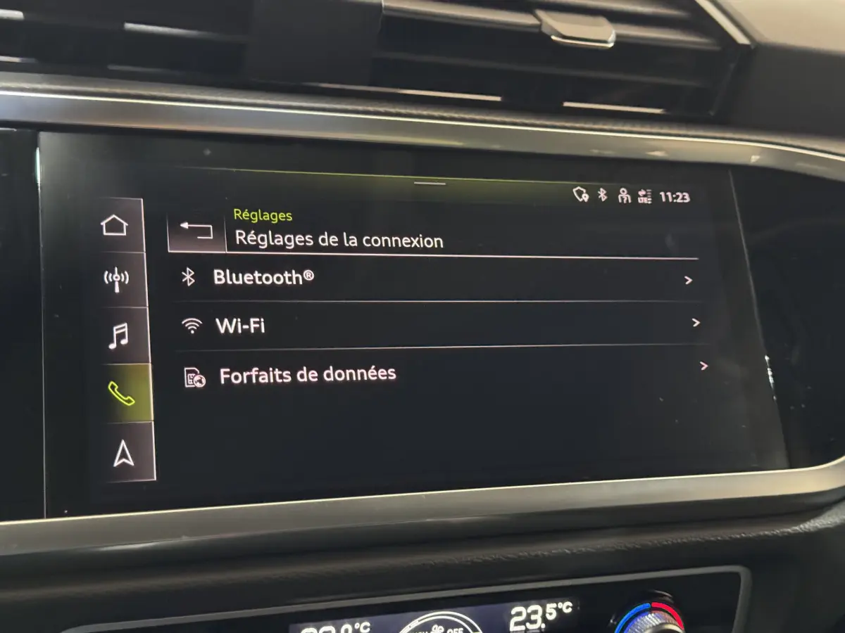 Écran tactile central de l'Audi Q3 Business Line 2022 montrant les réglages Bluetooth, Wi-Fi et forfaits de données.
