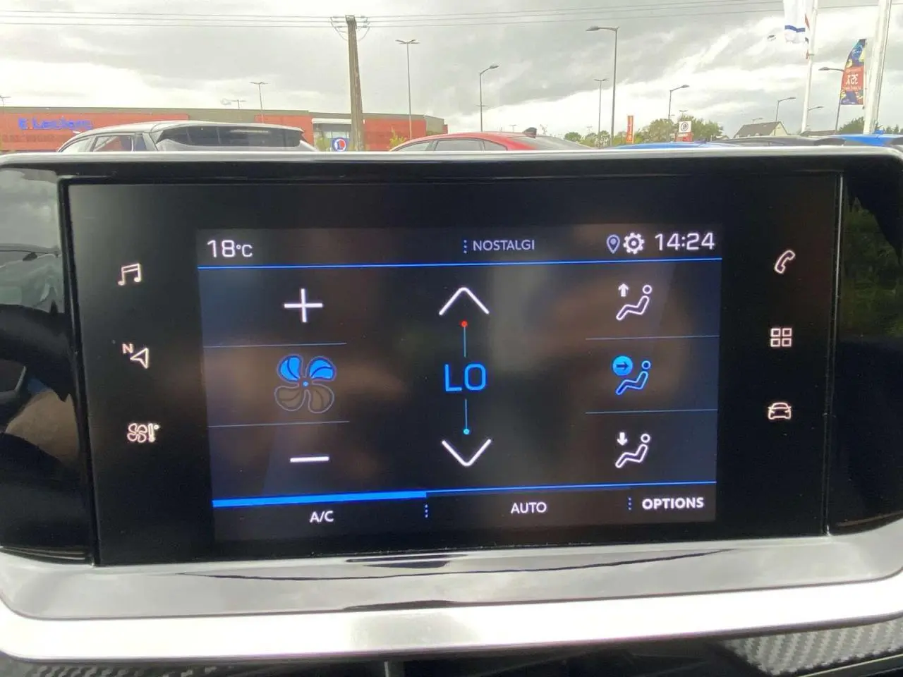 Écran tactile central de la Peugeot 208 2020 affichant les réglages de climatisation automatique à l'intérieur du véhicule.