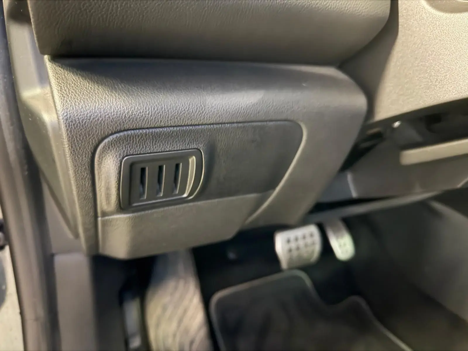 Détail de la commande de réglage sous le tableau de bord côté conducteur d’une Renault Mégane Break GT gris 2017.