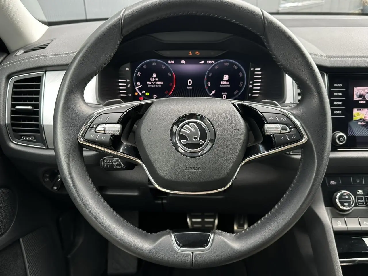 Vue rapprochée du volant noir de la Skoda Kodiaq 2024 avec affichage numérique et commandes intégrées.