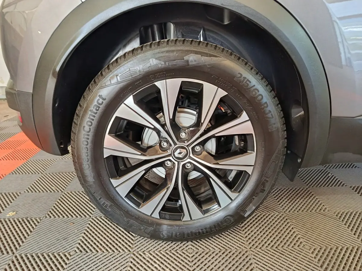 Gros plan sur la roue avant droite du Renault Captur gris foncé, mettant en valeur la jante alliage moderne et le pneu Continental.
