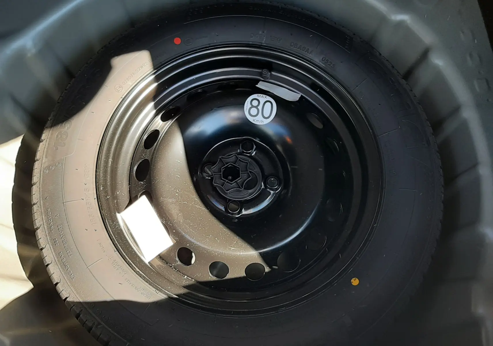 Vue plongeante sur la roue de secours noire du Dacia Sandero Stepway 2025, avec étiquette de vitesse 80 km/h visible.