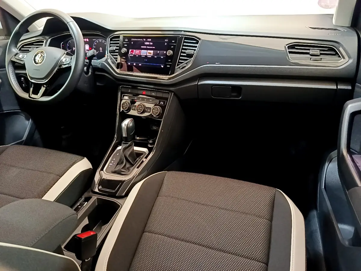 Intérieur du Volkswagen T-Roc 1.5 TSI 2020, vue de face sur tableau de bord noir et sièges tissu bicolore.