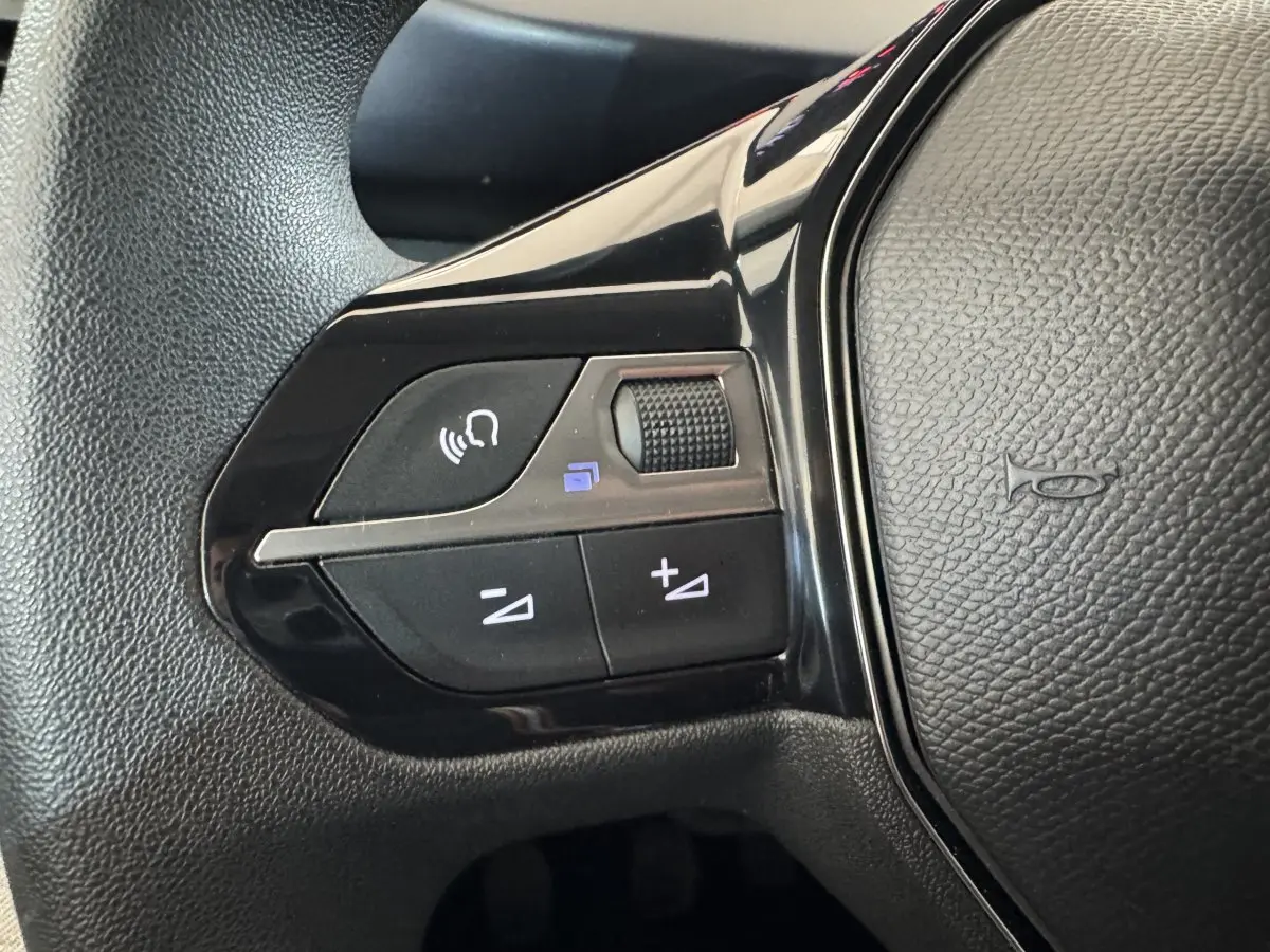 Gros plan sur les commandes de volume et téléphone du volant noir du Peugeot Rifter BlueHDi 100 Allure 2019.