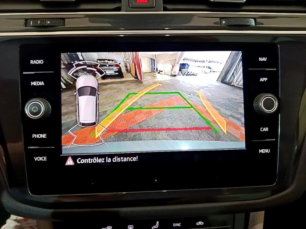 Écran tactile du système d’aide au stationnement arrière du Volkswagen Tiguan gris clair, vue caméra de recul.