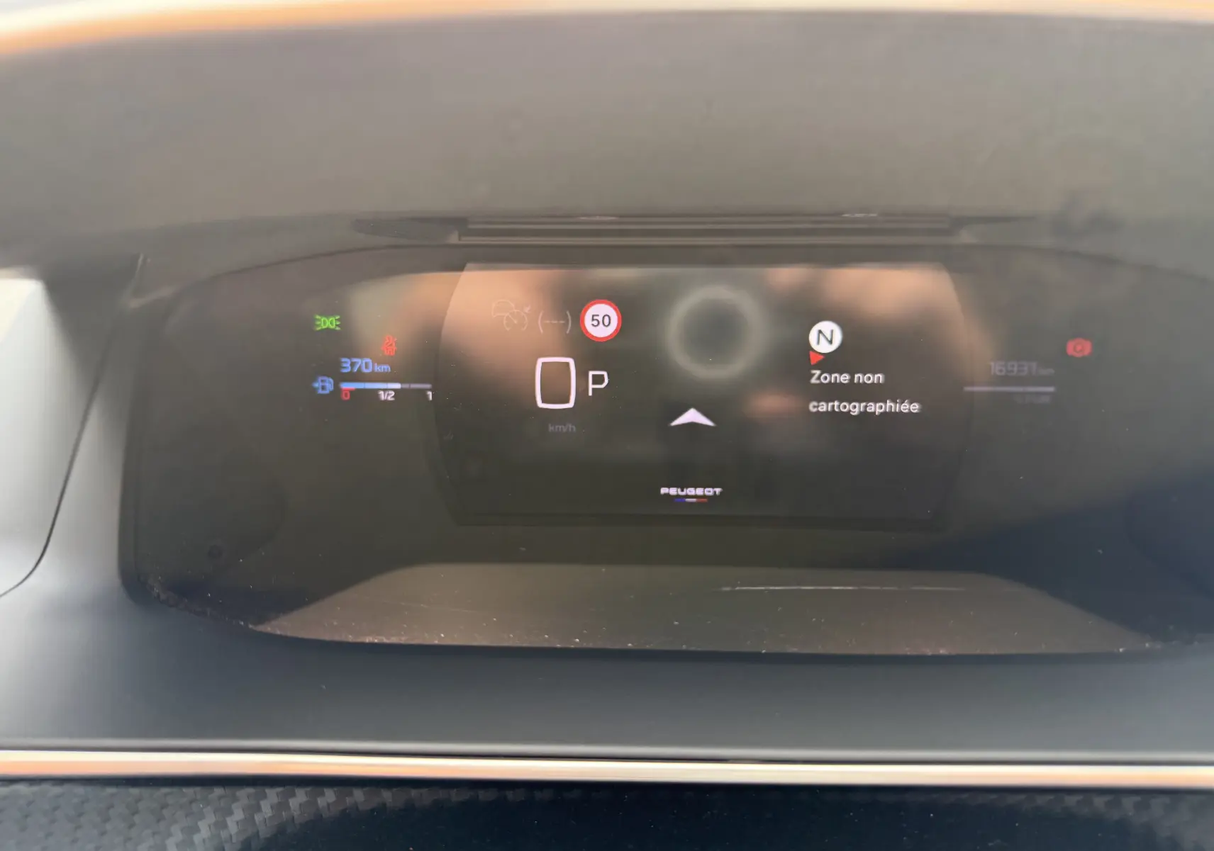 Tableau de bord numérique du Peugeot 208 Hybrid 145 GT, affichant la vitesse à 0 et une zone non cartographiée.