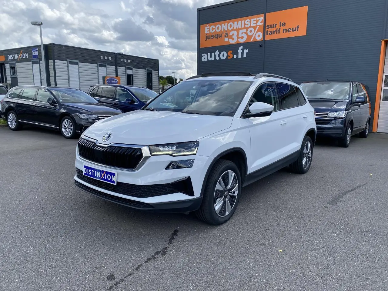 SKODA KAROQ blanc moon métallisé en 3/4 avant droit, avec toit ouvrant panoramique et jantes alliage 17 pouces.