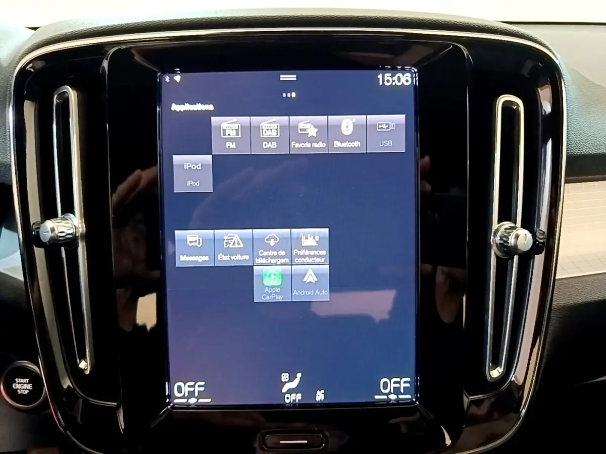 Écran tactile central allumé avec interface multimédia dans l'habitacle d'un Volvo XC40 gris clair.