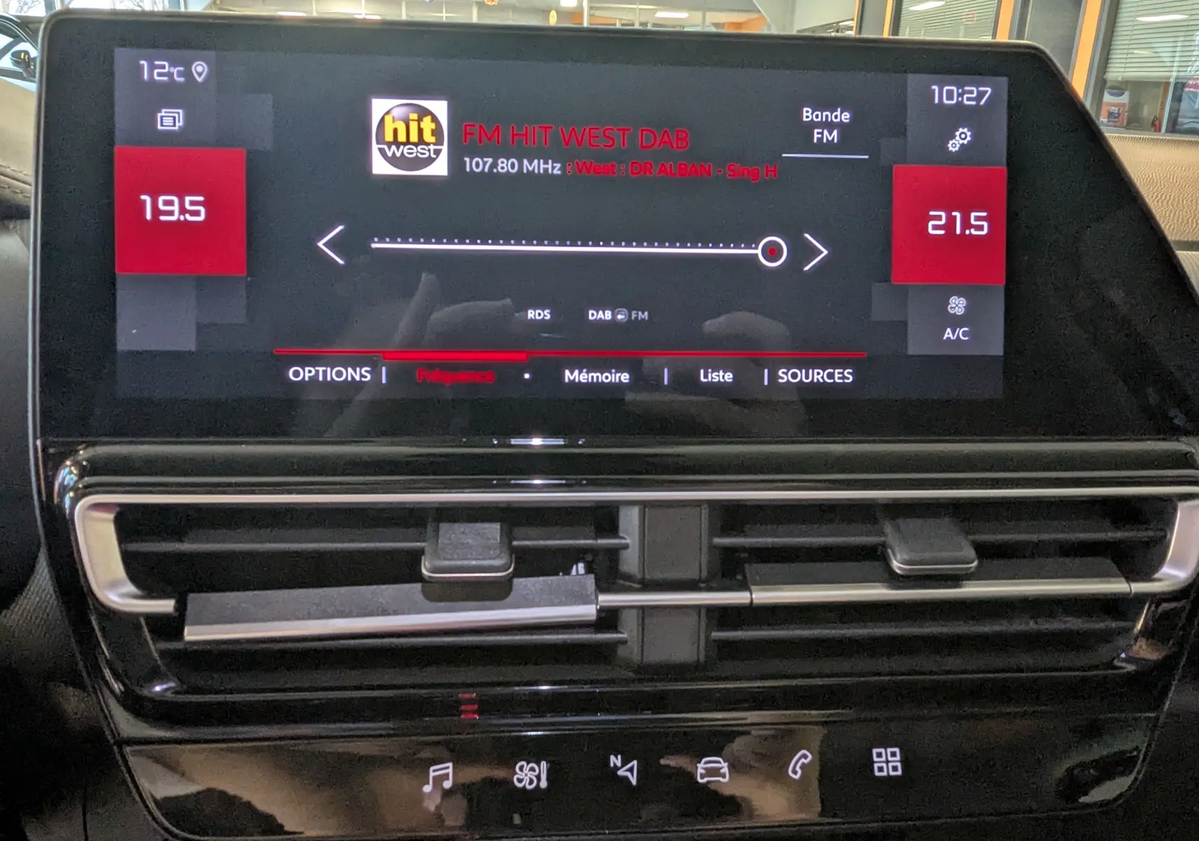 Vue rapprochée de l’écran tactile central du Citroën C5 Aircross noir 2024 affichant la radio FM et la climatisation.