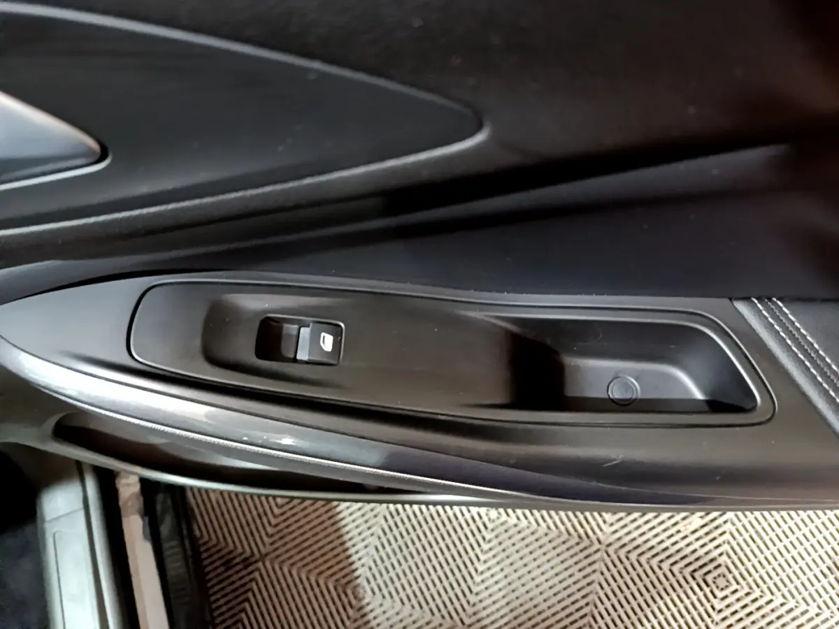 Détail de la commande de lève-vitre côté gauche intérieur noir de l'Opel Grandland X 1.5 Diesel 2021.
