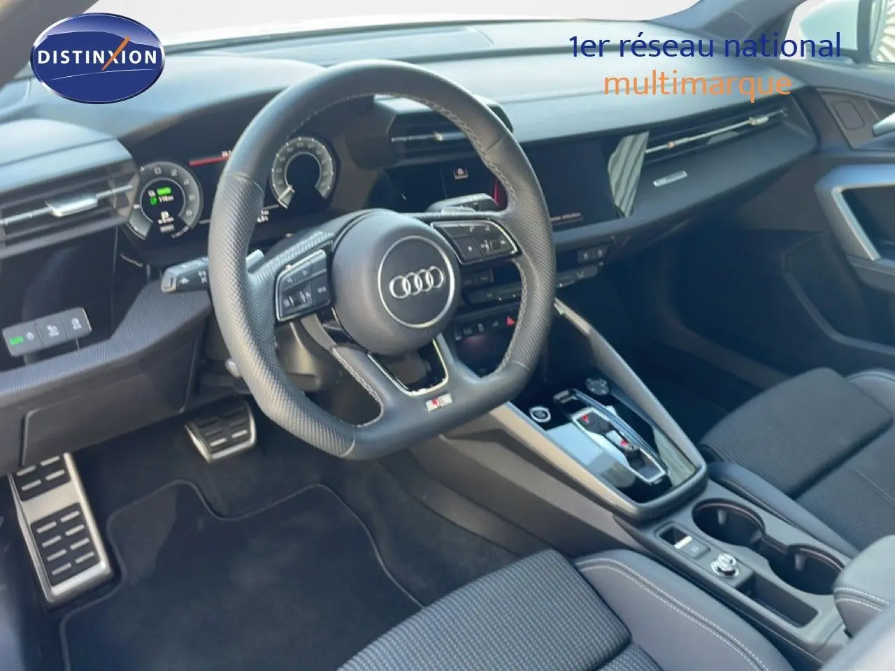 Vue intérieure côté conducteur de l'Audi A3 Sportback 40 TFSIe S-Line 2025 avec volant cuir et tableau de bord moderne.