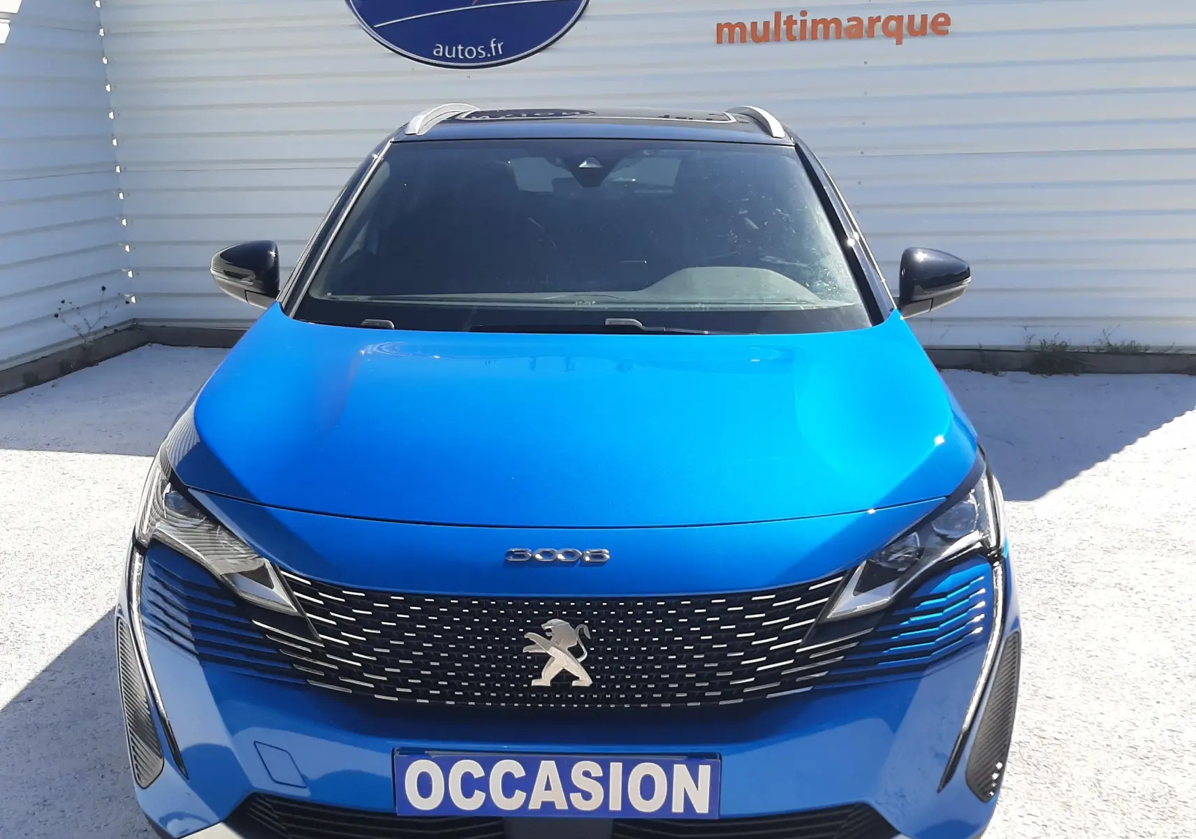 Vue avant d'un Peugeot 3008 GT 2023 bleu Vertigo avec toit noir, calandre noire et plaque "OCCASION" visible.