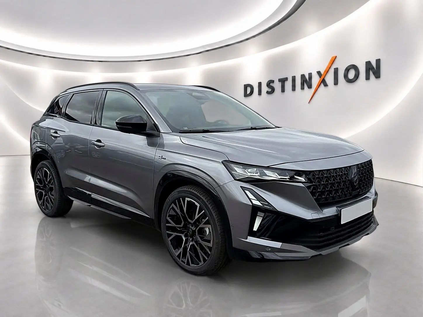 Vue 3/4 avant droite du Renault Austral gris schiste avec calandre noire et jantes alu noires stylisées.