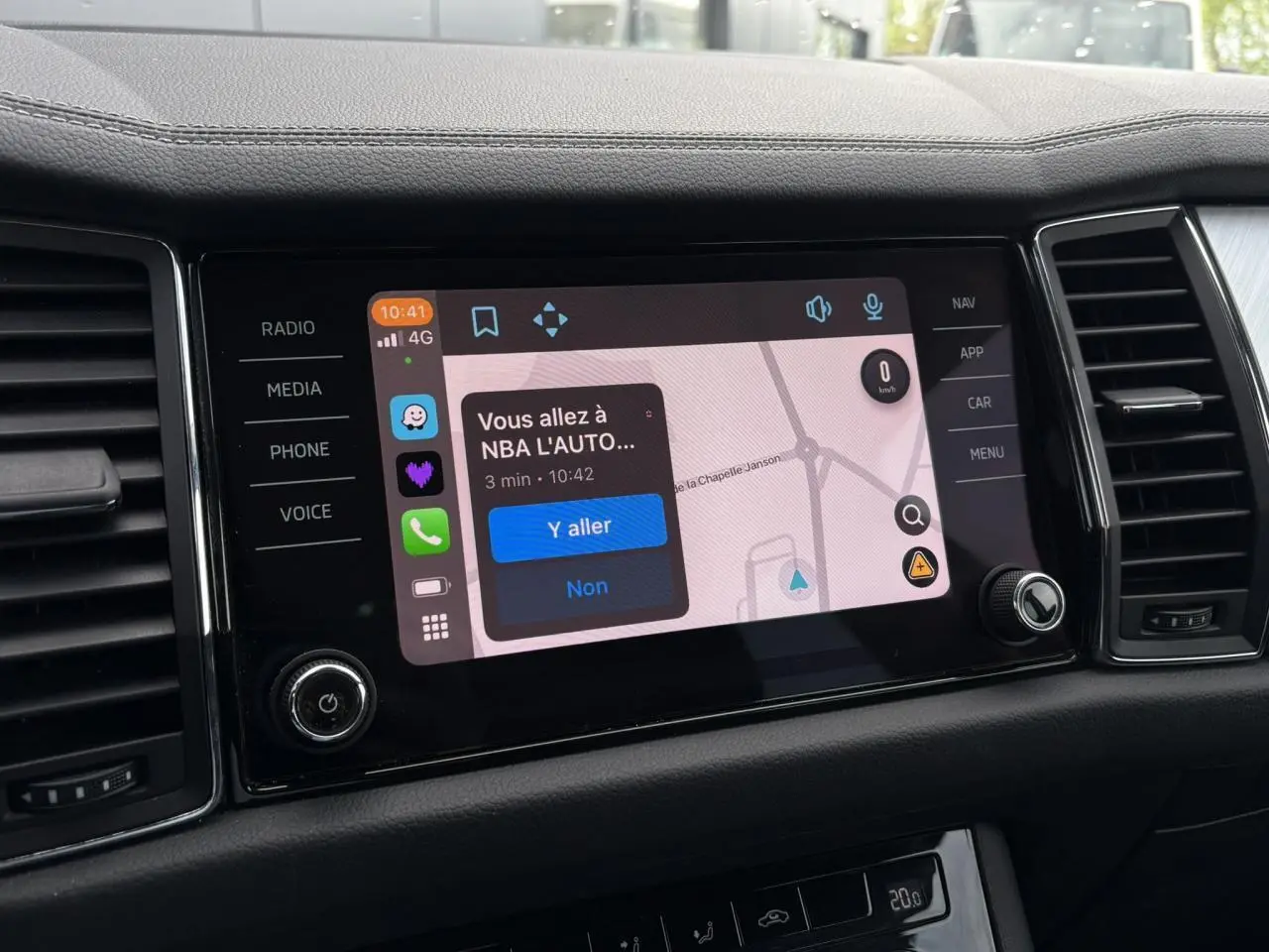 Écran tactile central du Skoda Kodiaq 2024 affichant une navigation avec options multimédia et commandes autour.
