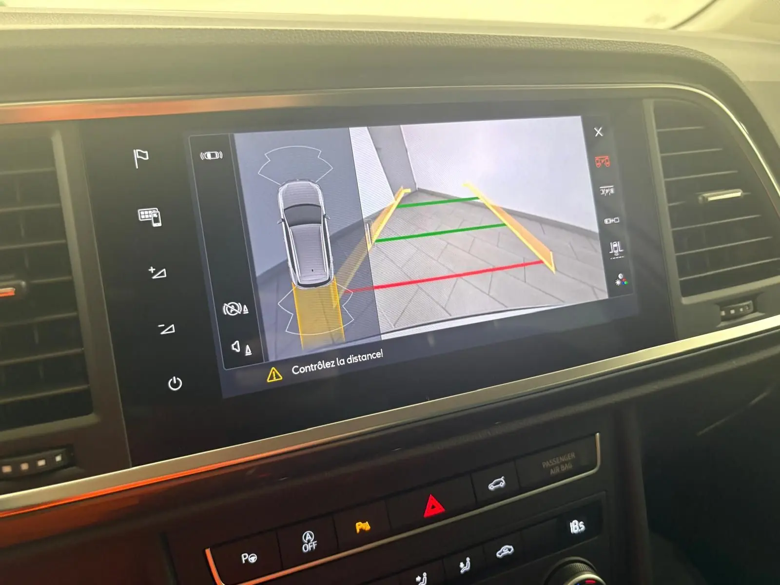 Écran tactile intérieur montrant la caméra de recul avec guidage coloré du SEAT Ateca Argent Reflex, vue de face.