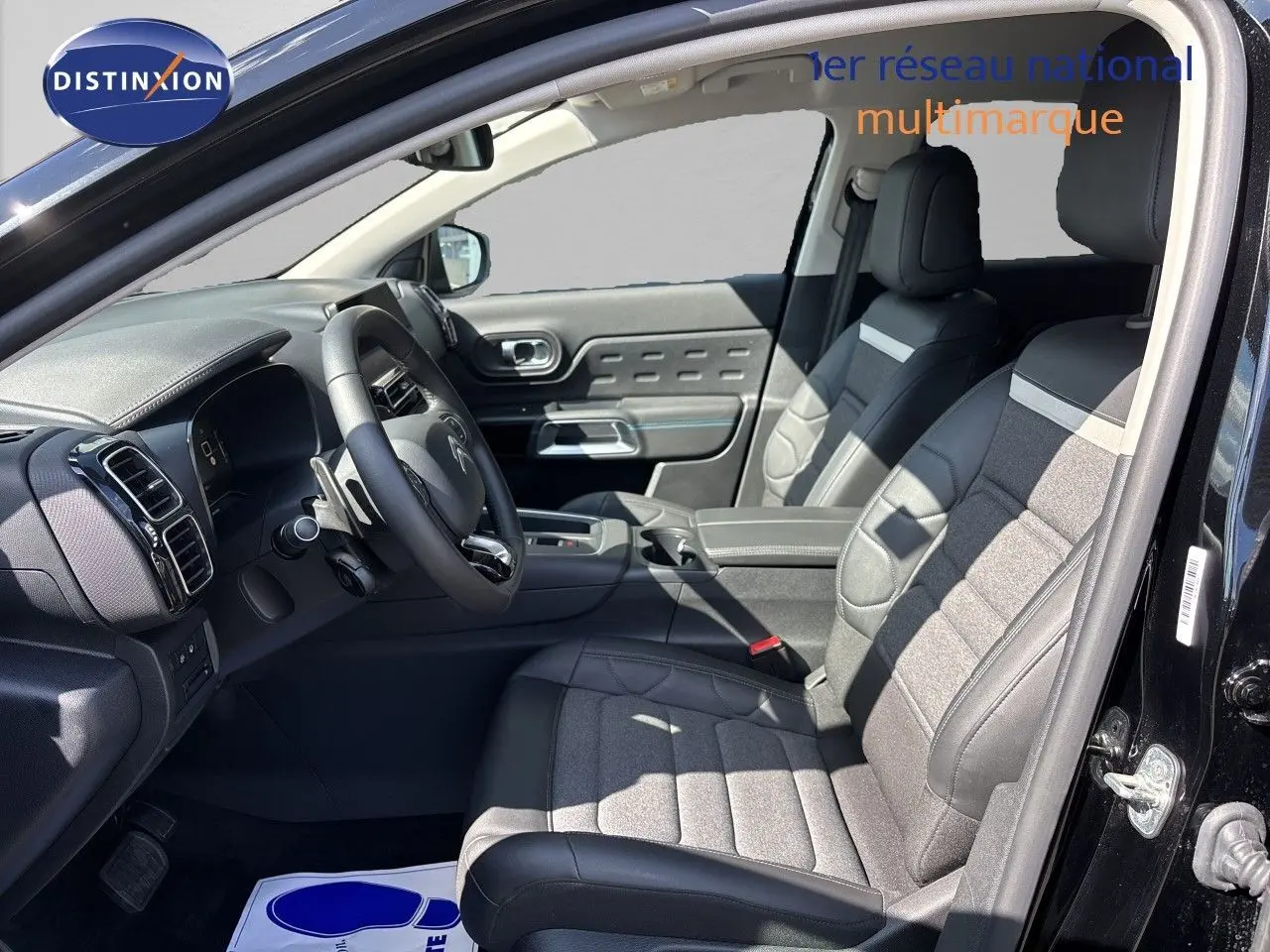 Vue intérieure côté conducteur du Citroën C5 Aircross noir Perla Nera, sièges tissu et cuir avec volant multifonction.