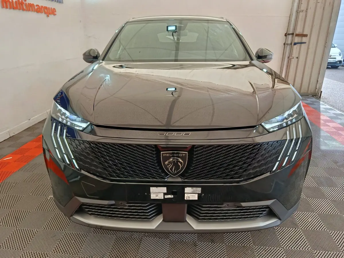 Vue frontale d'un Peugeot 3008 noir avec calandre noire et phares LED distinctifs en griffes.