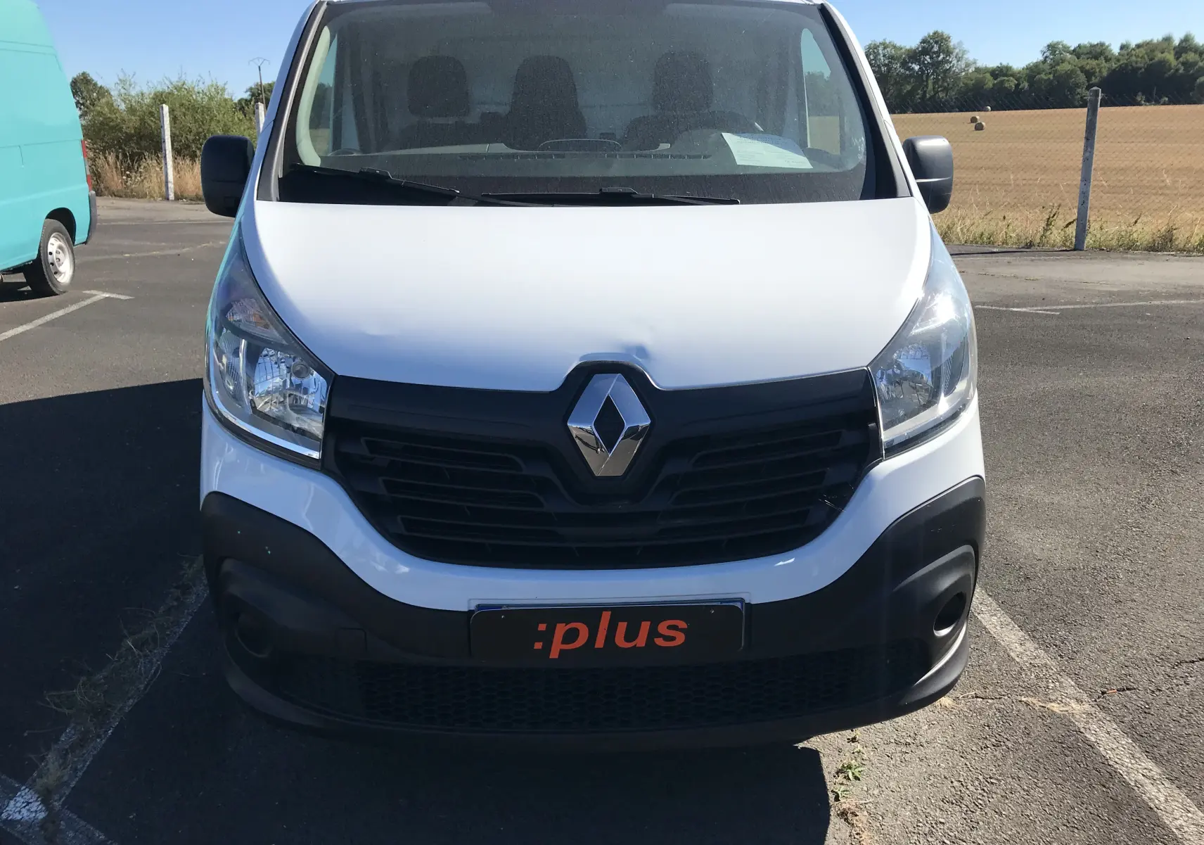 Vue frontale d'un Renault Trafic Fourgon blanc de 2017 avec calandre noire et plaque :plus visible.