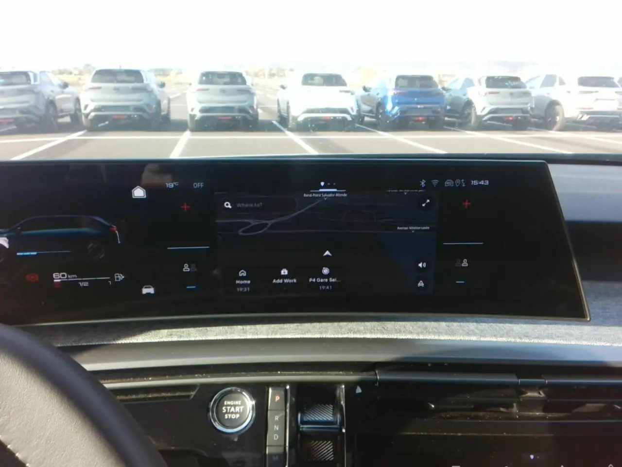 Vue intérieure du tableau de bord du Peugeot 5008 bleu foncé 2025, avec écran panoramique incurvé et console centrale noire brillante.