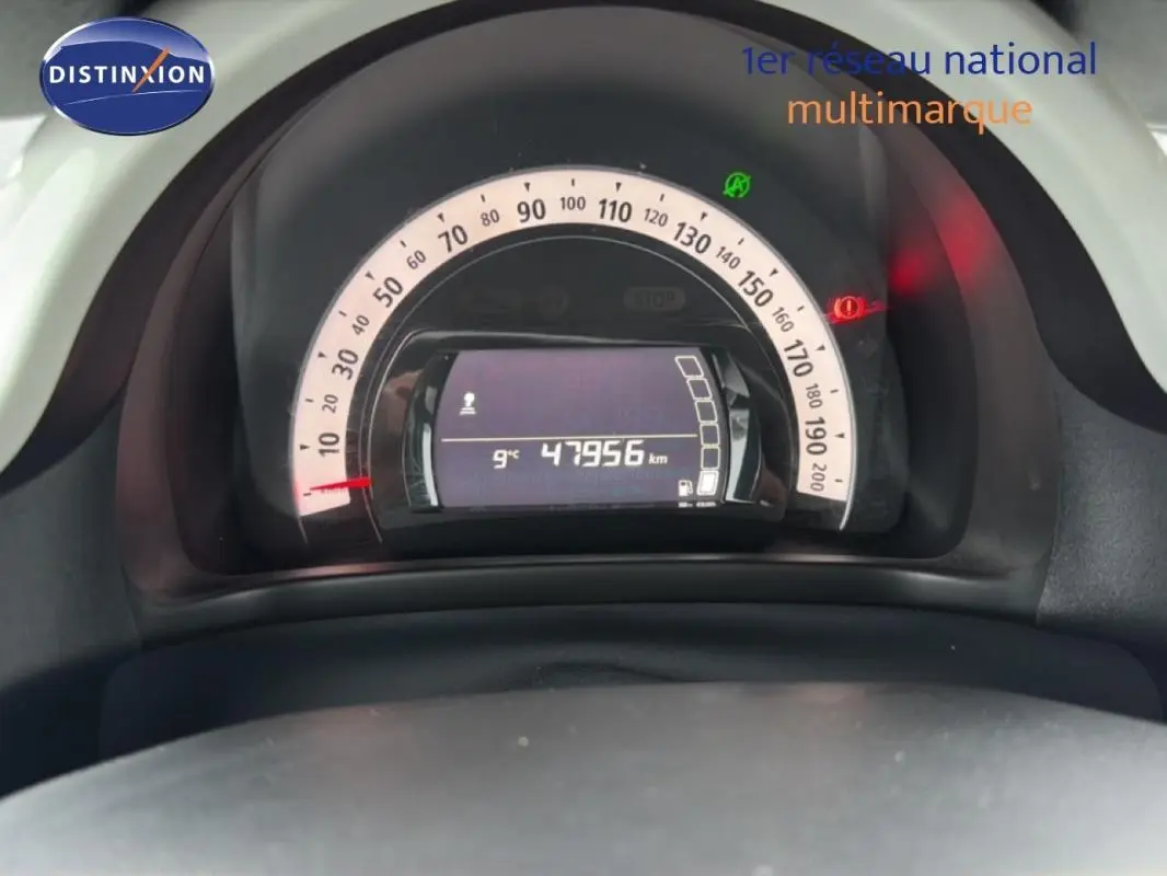 Vue rapprochée du tableau de bord de la Renault Twingo III gris foncé, affichant le compteur et l'odomètre à 47956 km.
