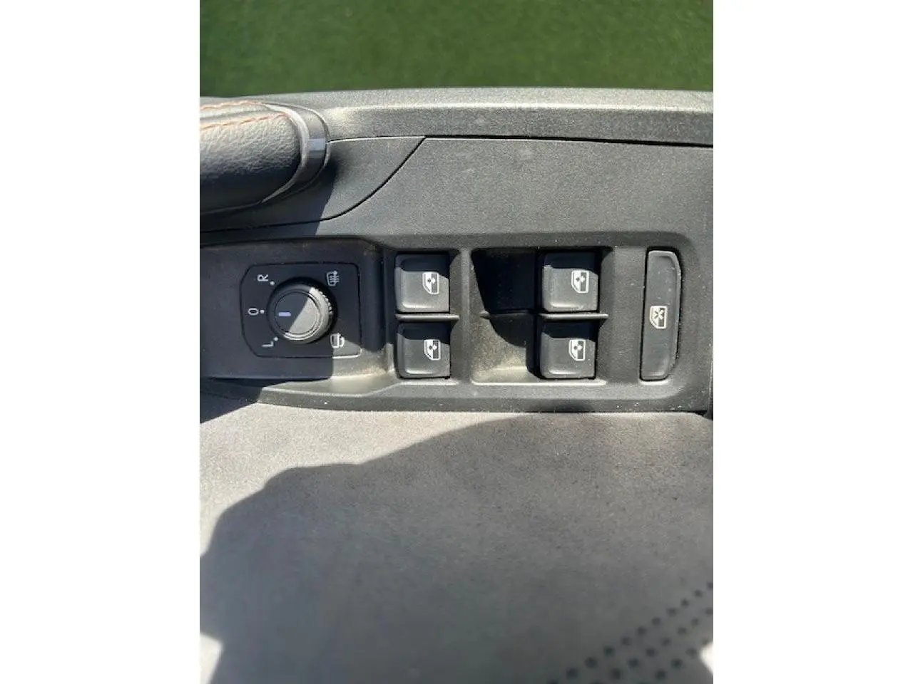 Gros plan sur les commandes de lève-vitres et réglage des rétroviseurs côté conducteur d'une CUPRA Formentor blanc neige.