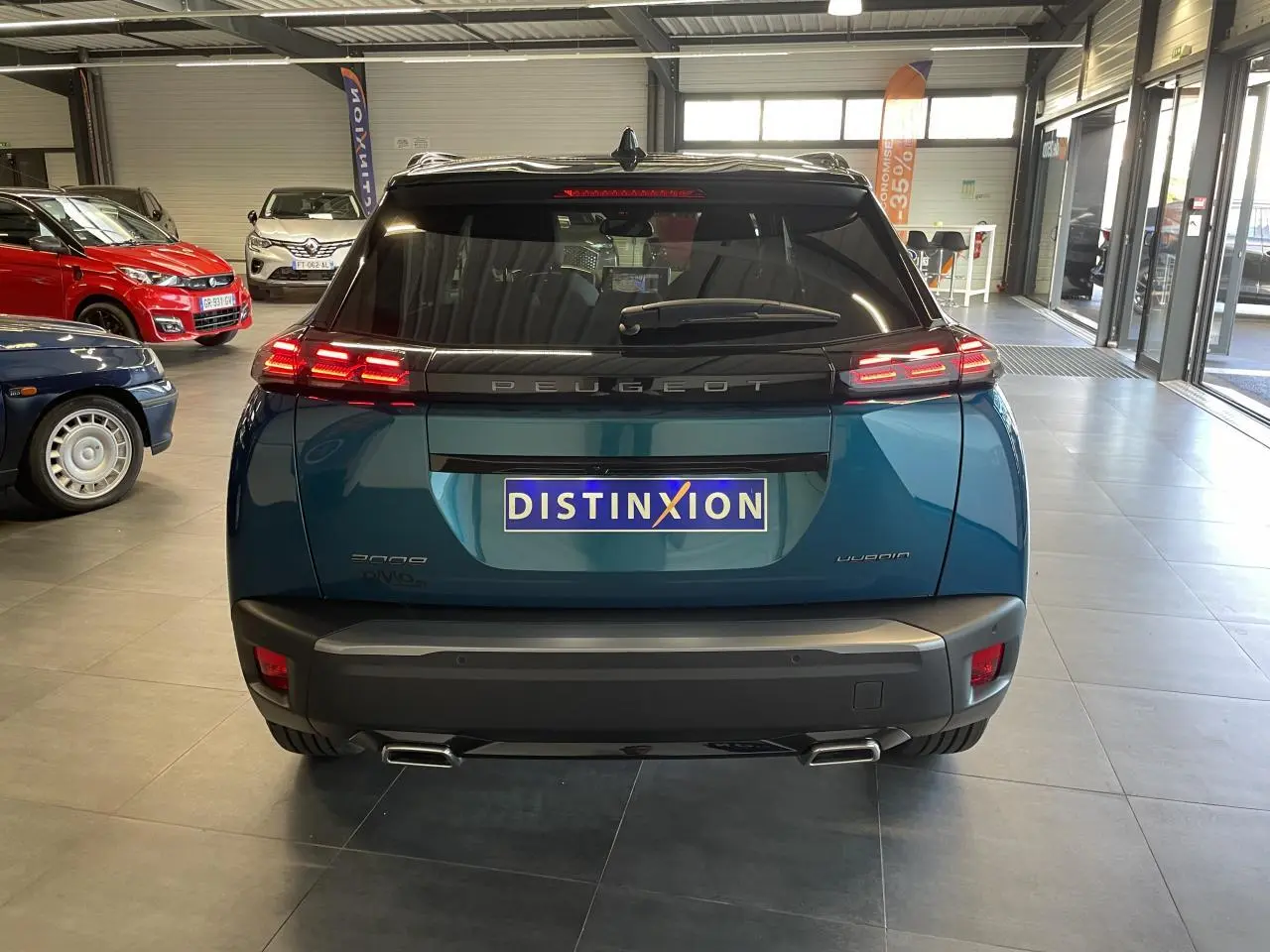 Vue arrière d’un Peugeot 2008 bleu Obsession avec feux arrière LED 3 griffes et double sortie d’échappement chromée.